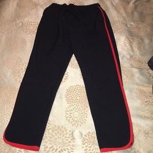 Black pants that have a red stripe